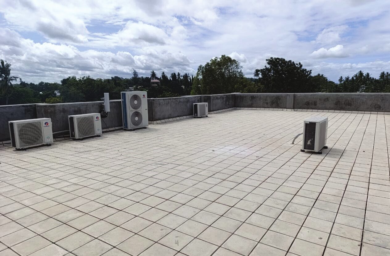 Tiled roof terrace with air-conditioning units